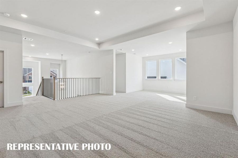 This spacious game room offers plenty of space to host those big game day parties!  REPRESENTATIVE PHOTO