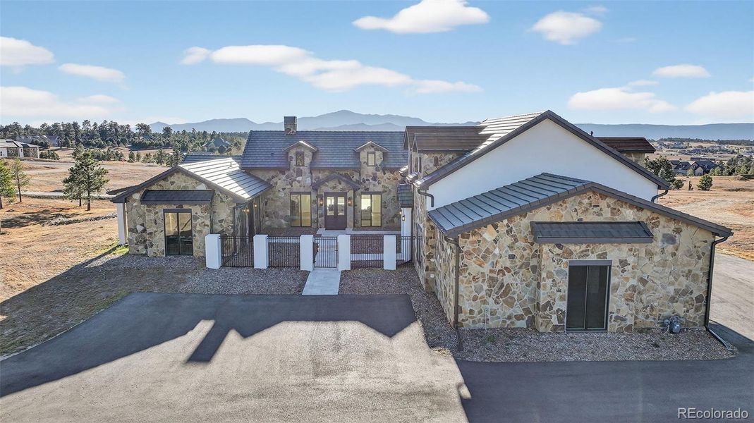 Front entry to the home (looking east to west) with Pikes Peak in the background,