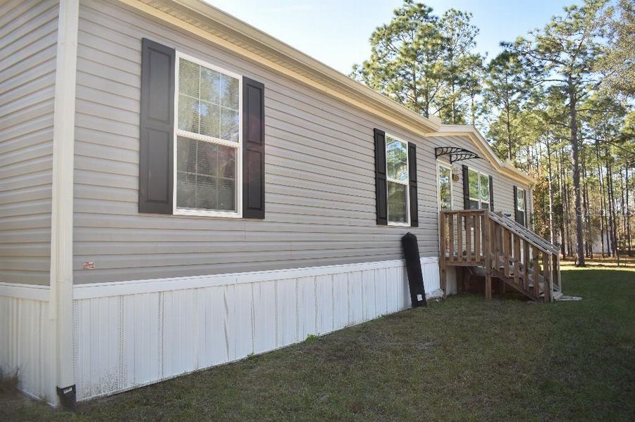 Exterior details and patio area of a home in , Williston (Image 33).