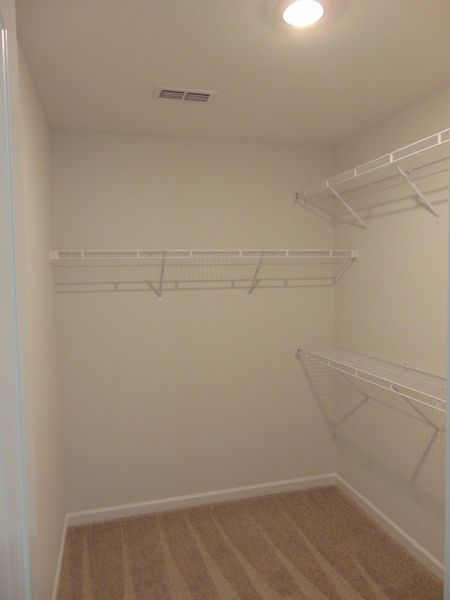 The primary closet with raised shelves for all your needs
