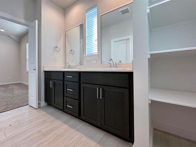 2nd Floor - Primary Bathroom with dual vanity sink and standing shower.