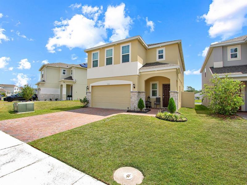 Front exterior of a new home in , Kissimmee, FL, highlighting curb appeal (Image 23).