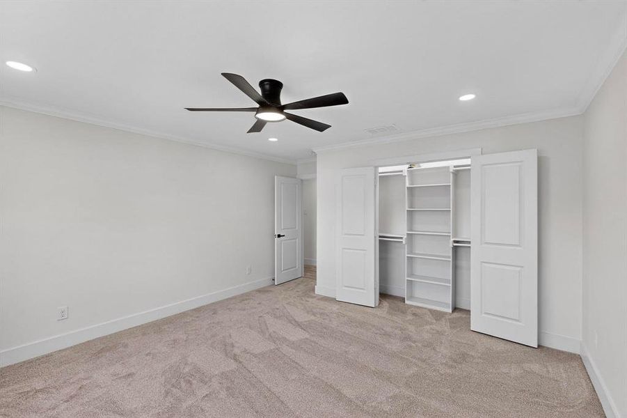 Unfurnished bedroom featuring ornamental molding, recessed lighting, light carpet, a closet, and ceiling fan