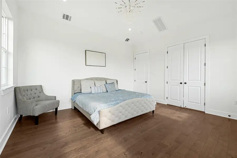 Spacious master bedroom with abundant natural light and elegant design.
