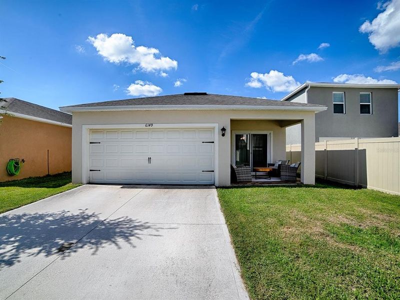 Front exterior of a new home in Windrose, Apopka, FL, highlighting curb appeal (Image 2). Front exterior of a new home in Windrose, Apopka, FL, highlighting curb appeal (Image 2).