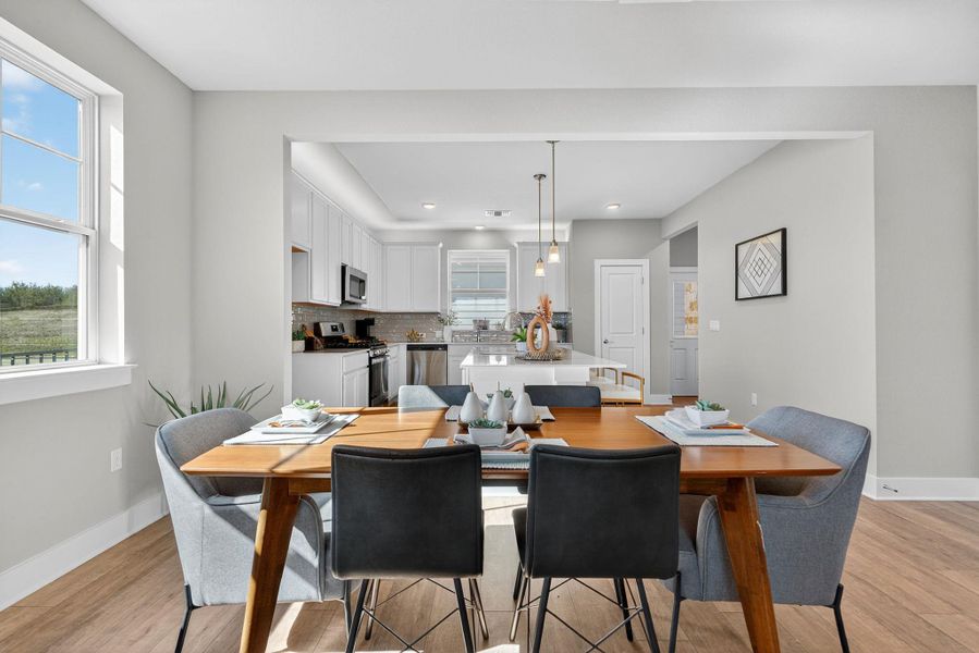 Dining area with baseboards and light wood-style flooring