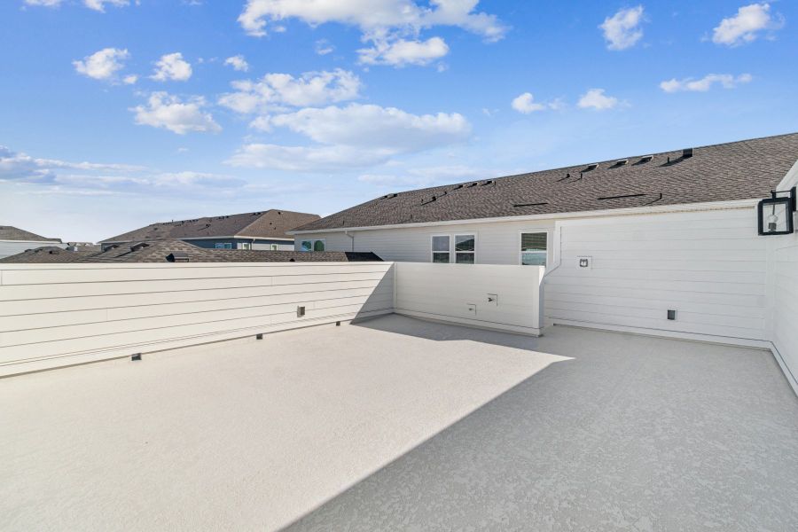 Exterior details and patio area of a home in Seven Pines 24' Rear Entry Townhomes, Jacksonville (Image 4).