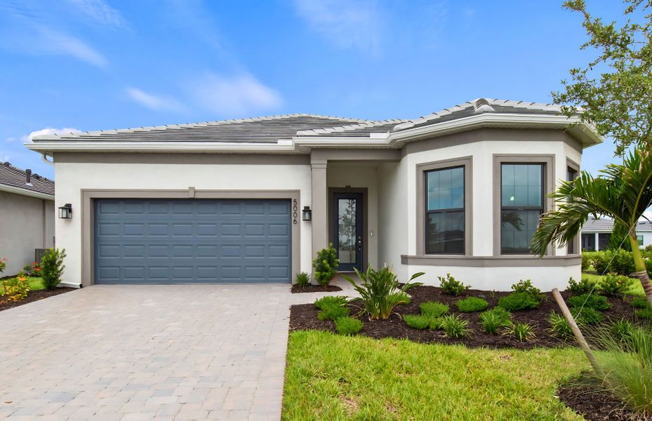 Front exterior of a new home in Del Webb Catalina, Lakewood Ranch, FL, highlighting curb appeal (Image 26). Front exterior of a new home in Del Webb Catalina, Lakewood Ranch, FL, highlighting curb appeal (Image 26).