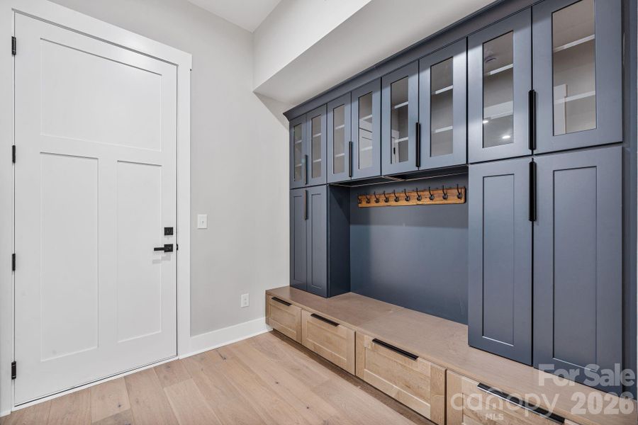 Drop-zone with ample built-ins positioned as you enter from the garage
