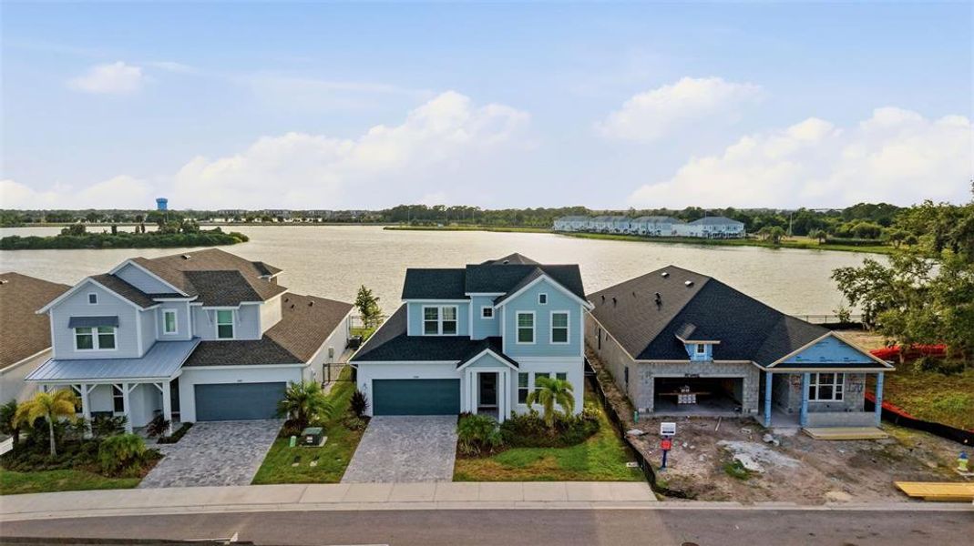 Front exterior of a new home in Emerald Landing at Waterside at Lakewood Ranch – Lake Series, Sarasota, FL, highlighting curb appeal (Image 28). Front exterior of a new home in Emerald Landing at Waterside at Lakewood Ranch – Lake Series, Sarasota, FL, highlighting curb appeal (Image 28).