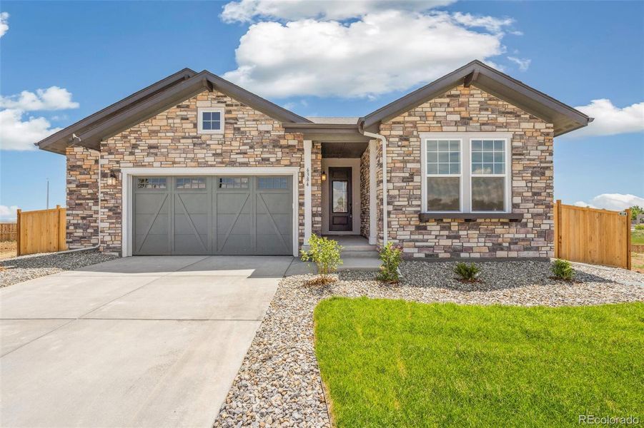 Front exterior of a new home in Windsong, Thornton, CO, highlighting curb appeal (Image 22).