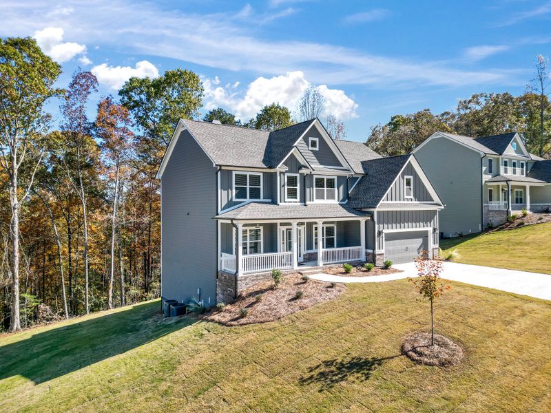 Front exterior of a new home in Woodland Hills, Loganville, GA, highlighting curb appeal (Image 19). Front exterior of a new home in Woodland Hills, Loganville, GA, highlighting curb appeal (Image 19).