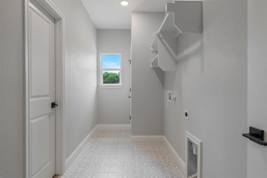 Clothes washing area featuring tile flooring, electric dryer hookup, and washer hookup