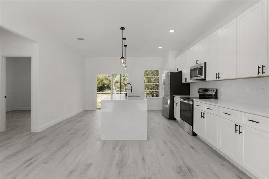 Lots of quartz countertop space in the kitchen