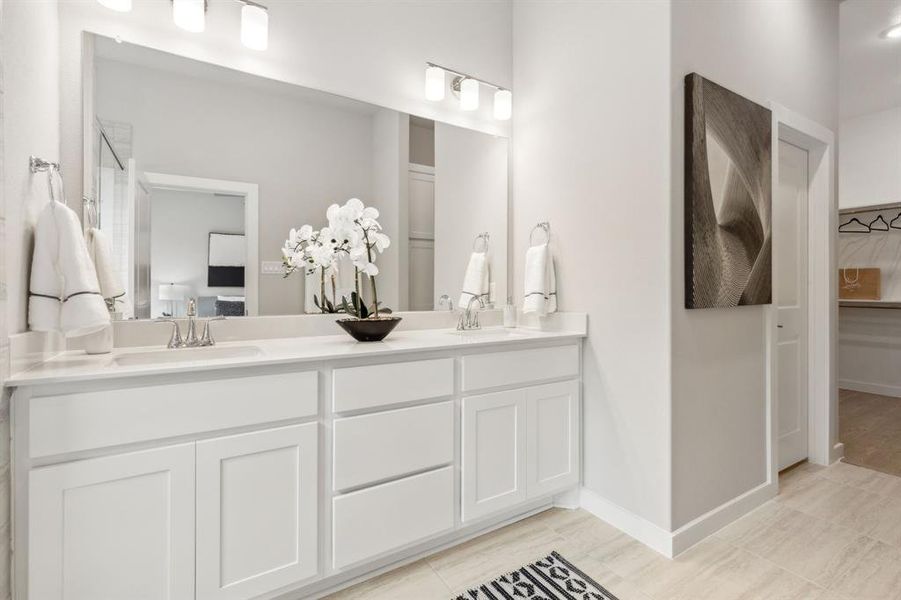 Bathroom featuring tile patterned flooring and dual bowl vanity