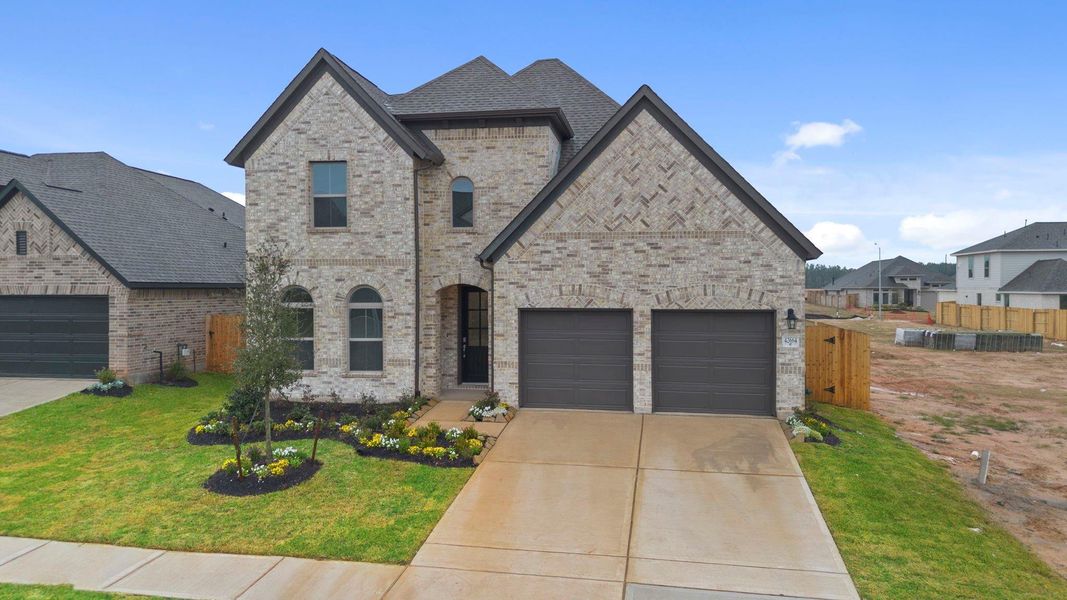 Front exterior of a new home in Escondido, Magnolia, TX, highlighting curb appeal (Image 20).