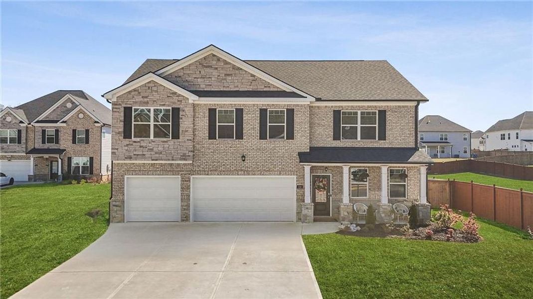 Front exterior of a new home in Independence, Loganville, GA, highlighting curb appeal (Image 2).
