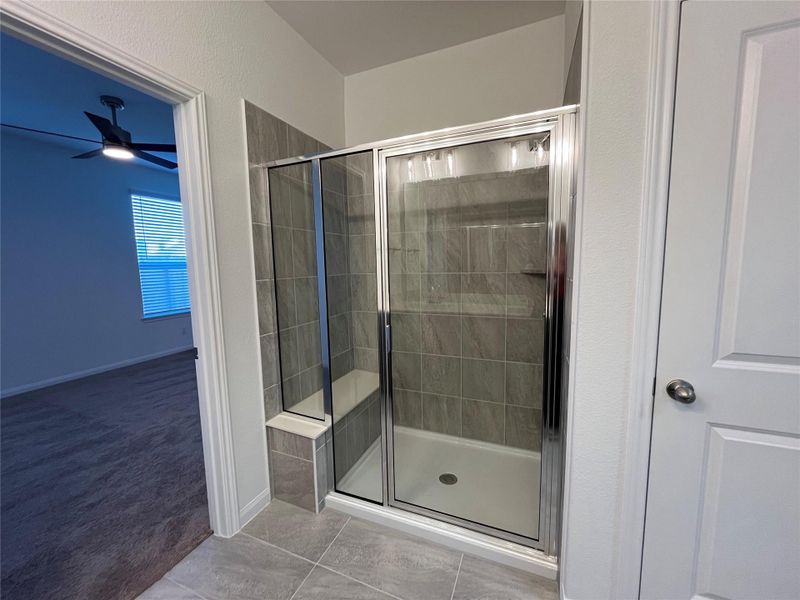 Large walk-in shower and bench. For demonstration purposes only. This will be the same interior layout. Colors can vary.