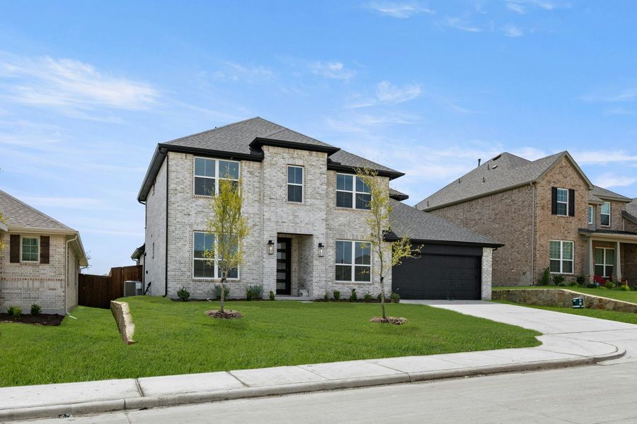 Front exterior of a new home in Westside Preserve, Midlothian, TX, highlighting curb appeal (Image 2).