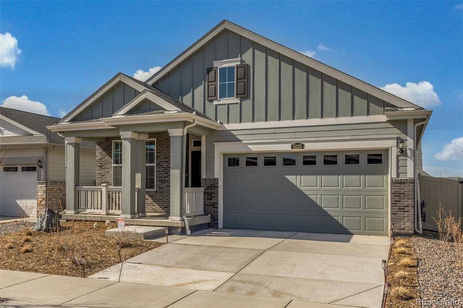 Front exterior of a new home in Green Valley Ranch Active Adult, Aurora, CO, highlighting curb appeal (Image 24).