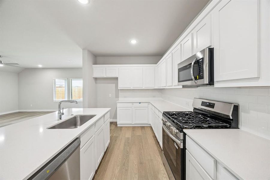 Kitchen in the Hayden home plan by Trophy Signature Homes – REPRESENTATIVE PHOTO