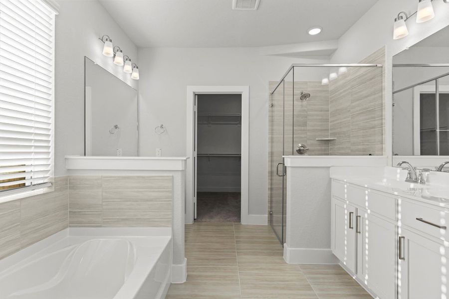 The luxurious primary bath feels like a private spa! Enjoy a deep soaking tub, walk-in shower with tile surround, and dual vanities—all crafted with CastleRock’s signature design and attention to comfort. The luxurious primary bath feels like a private spa! Enjoy a deep soaking tub, walk-in shower with tile surround, and dual vanities—all crafted with CastleRock’s signature design and attention to comfort.