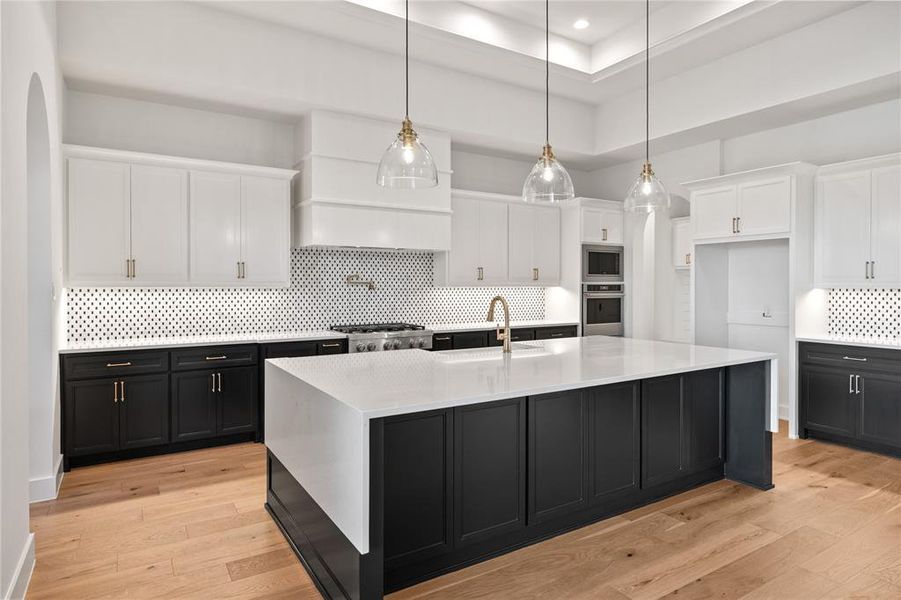 Kitchen featuring dark cabinetry, white cabinets, backsplash, decorative light fixtures, and recessed lighting Kitchen featuring dark cabinetry, white cabinets, backsplash, decorative light fixtures, and recessed lighting