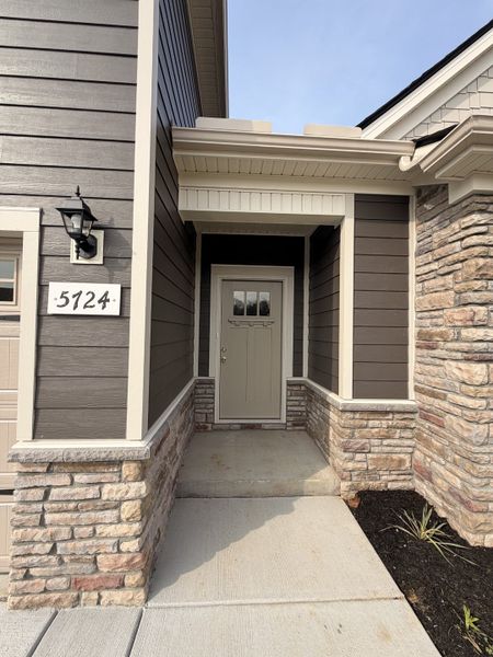 Home features a Stone Front with the very popular Craftsman Style front door!
