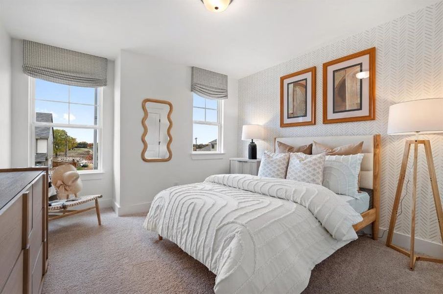 Carpeted bedroom featuring wallpapered walls and baseboards
