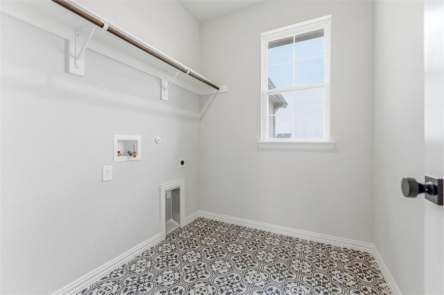 Laundry room with hookup for a gas dryer, hookup for an electric dryer, hookup for a washing machine, and tile patterned floors