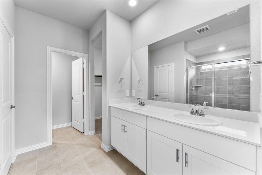 Full bath with double vanity, a stall shower, tile patterned flooring, and recessed lighting Full bath with double vanity, a stall shower, tile patterned flooring, and recessed lighting