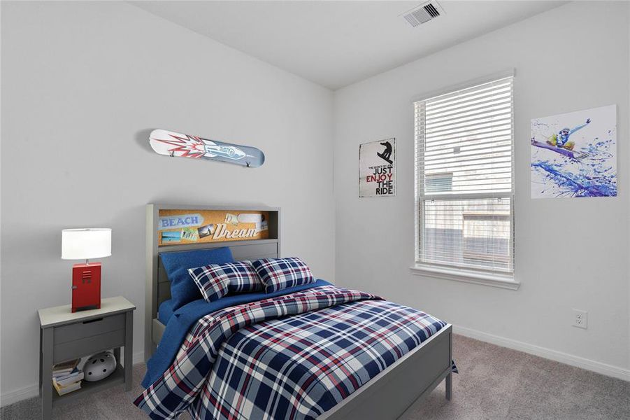 Secondary bedroom features plush carpet, neutral paint, lighting, large window with privacy blinds and ample sized closet space.