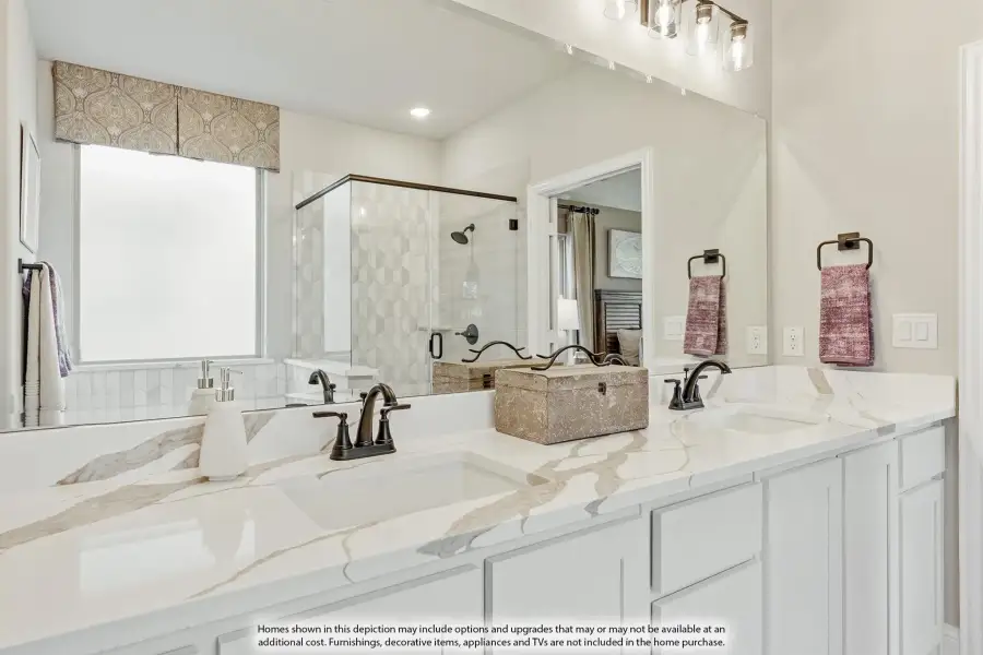 Master bathroom with double vanity, marble countertops, white cabinets, and glass walk-in shower visible in mirror reflection. Master bathroom with double vanity, marble countertops, white cabinets, and glass walk-in shower visible in mirror reflection.