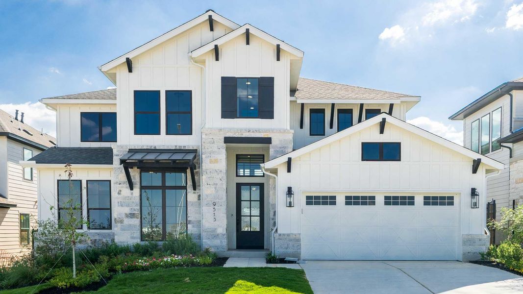 Modern inspired farmhouse featuring stone siding, roof with shingles, board and batten siding, concrete driveway, and a garage