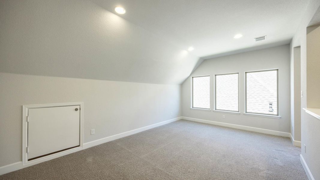Additional living space with light colored carpet, vaulted ceiling, and recessed lighting Additional living space with light colored carpet, vaulted ceiling, and recessed lighting