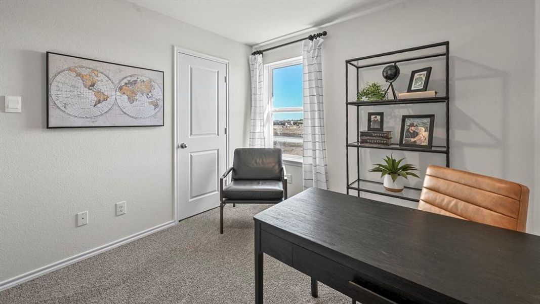 Office featuring carpet flooring and a textured wall