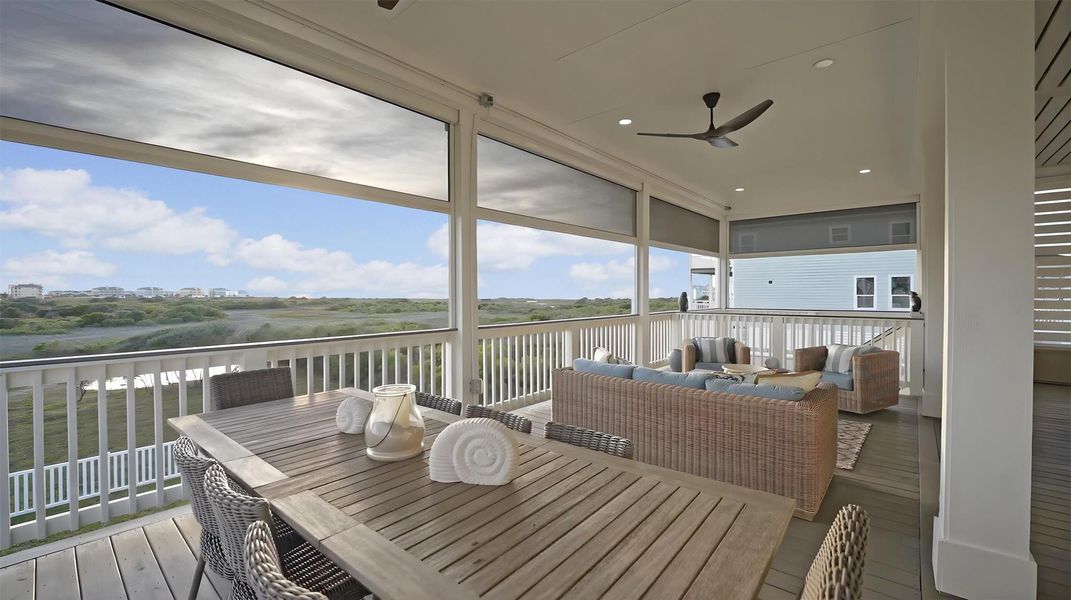 The spacious, screened-in porch with motorized controls and coastal grade ceiling fans.