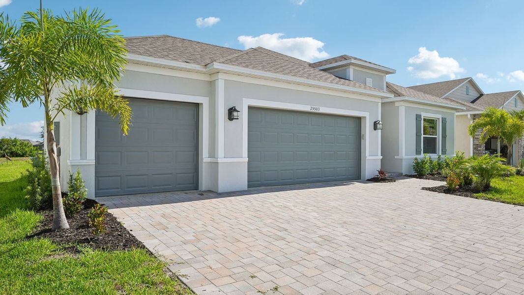 Front exterior of a new home in Heritage Station, Punta Gorda, FL, highlighting curb appeal (Image 26).