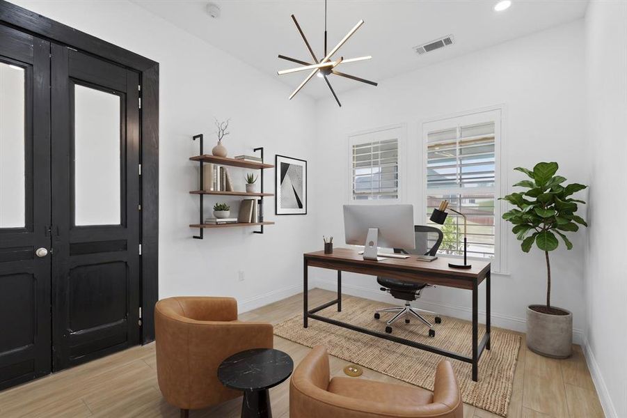 Bright room featuring blonde wood-finish flooring and a contemporary chandelier Bright room featuring blonde wood-finish flooring and a contemporary chandelier