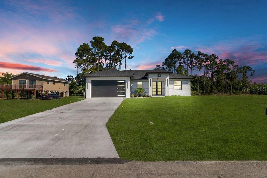 Front exterior of a new home in , Lehigh Acres, FL, highlighting curb appeal (Image 21).