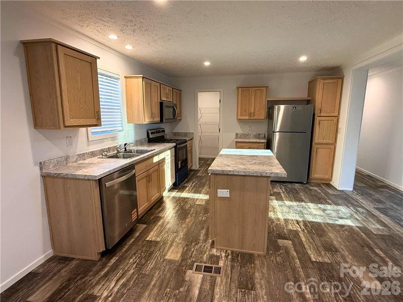 Beautiful kitchen with island, walk in pantry, soft close cabinet doors.