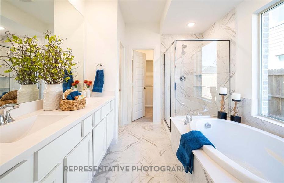 Full bathroom featuring a marble finish shower, vanity, light marble finish flooring, a bath, and recessed lighting