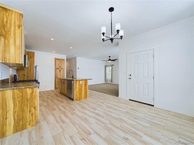 Kitchen featuring light flooring, hanging light fixture