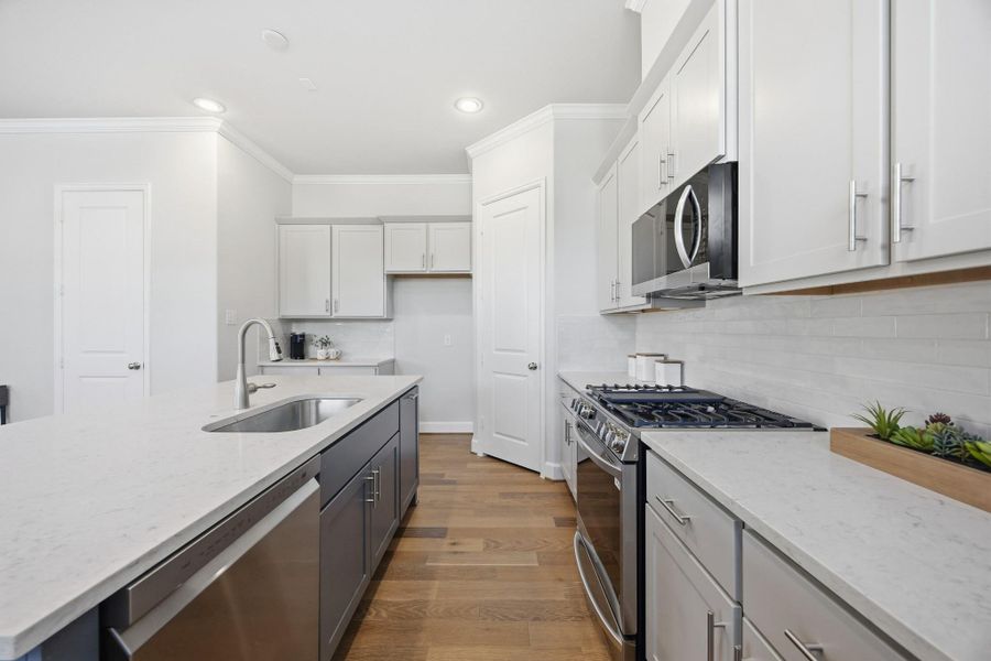 Sophistication Redefined: The kitchen's centerpiece—an elegant island—awaits the glow of your chosen pendant light upgrade, making every moment in the heart of the home shine brighter.