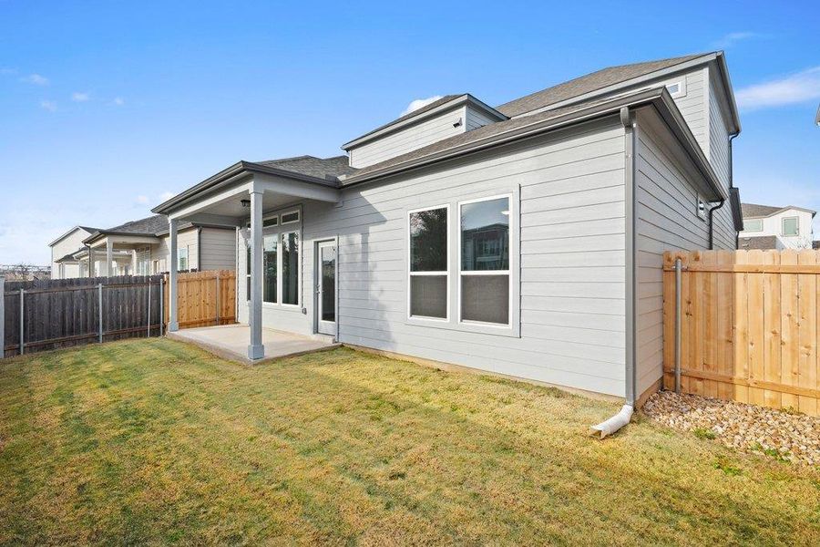 Back of house with a patio area, a fenced backyard, and a shingled roof