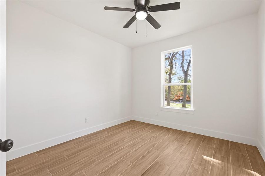 Unfurnished room featuring wood finish floors and ceiling fan