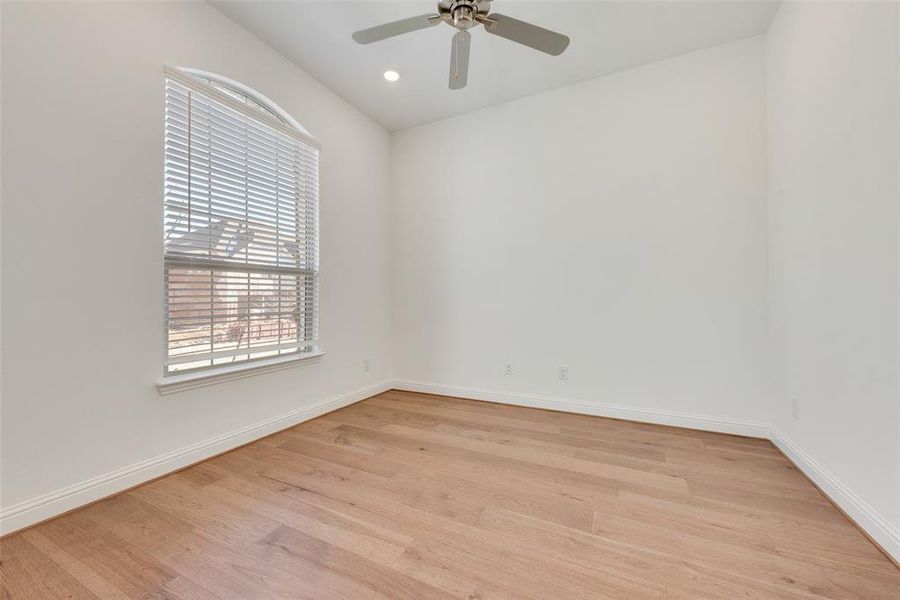 Spare room featuring ceiling fan and light hardwood / wood-style flooring