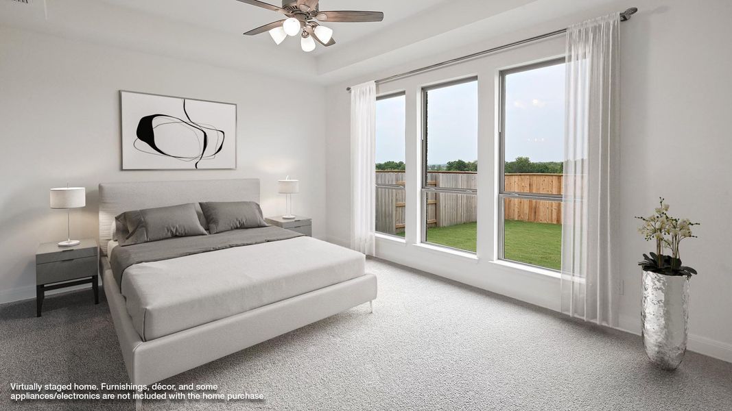 Bedroom featuring carpet floors, baseboards, and ceiling fan