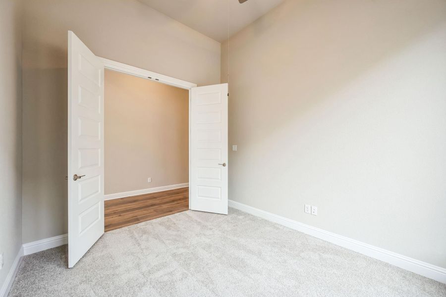 Unfurnished bedroom featuring baseboards and light colored carpet Unfurnished bedroom featuring baseboards and light colored carpet