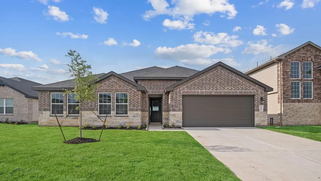 Front exterior of a new home in Tamarron, Fulshear, TX, highlighting curb appeal (Image 1). Front exterior of a new home in Tamarron, Fulshear, TX, highlighting curb appeal (Image 1).